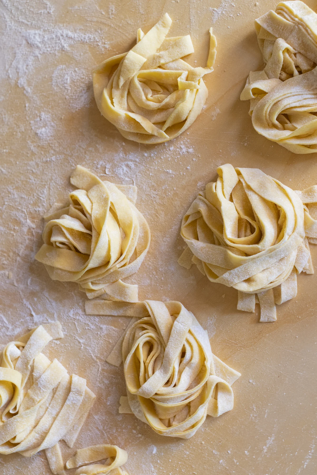 Nests of fresh tagliatelle on a floured worktop in The Monteleone’s kitchen