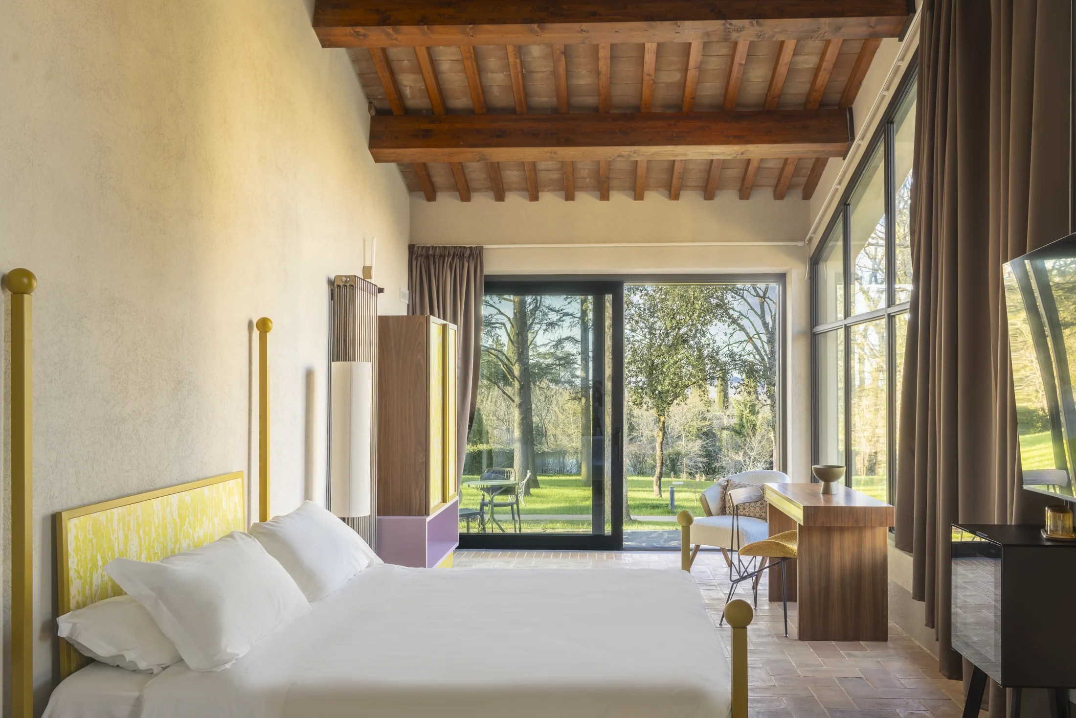 A room with windows opening onto The Monteleone’s garden