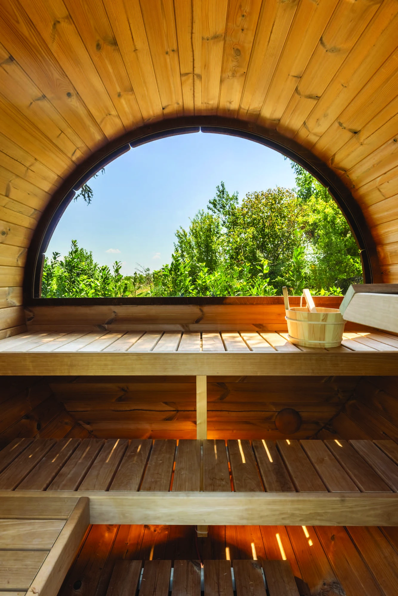 Inside the sauna at The Monteleone, with its curved window looking out onto the greenery